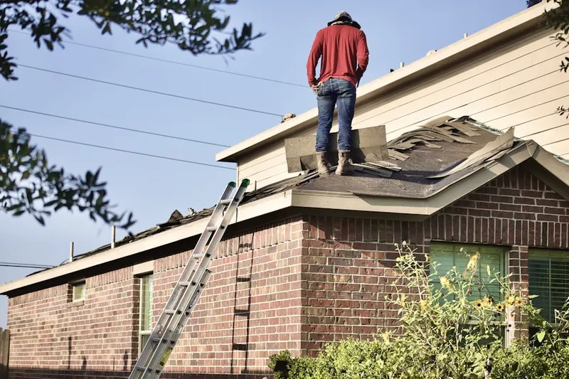 Professional roofer working on a residential roof in Hustons Mill